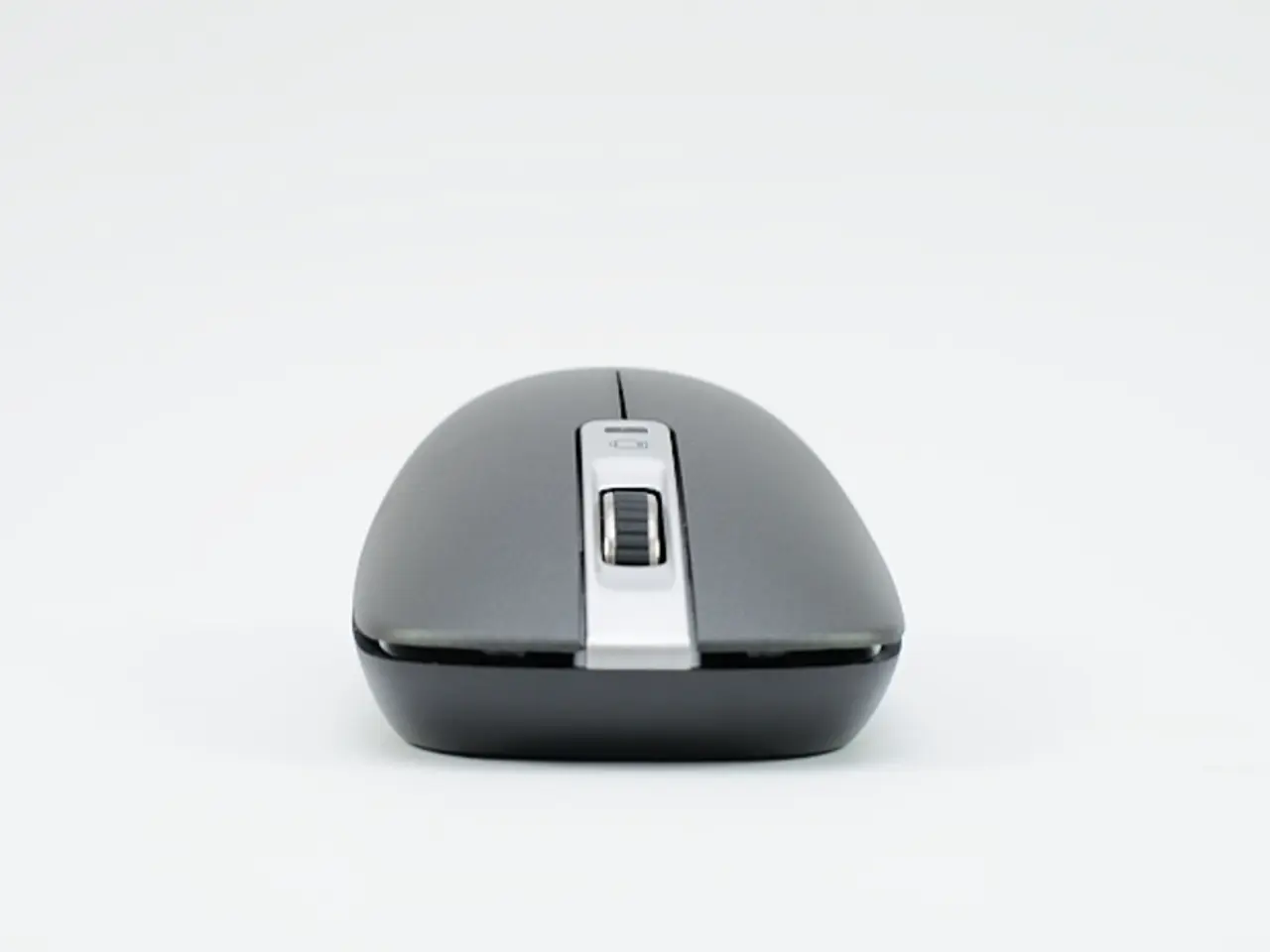 In this picture we can see a wireless mouse here, there is a scroll button here, we can see left...