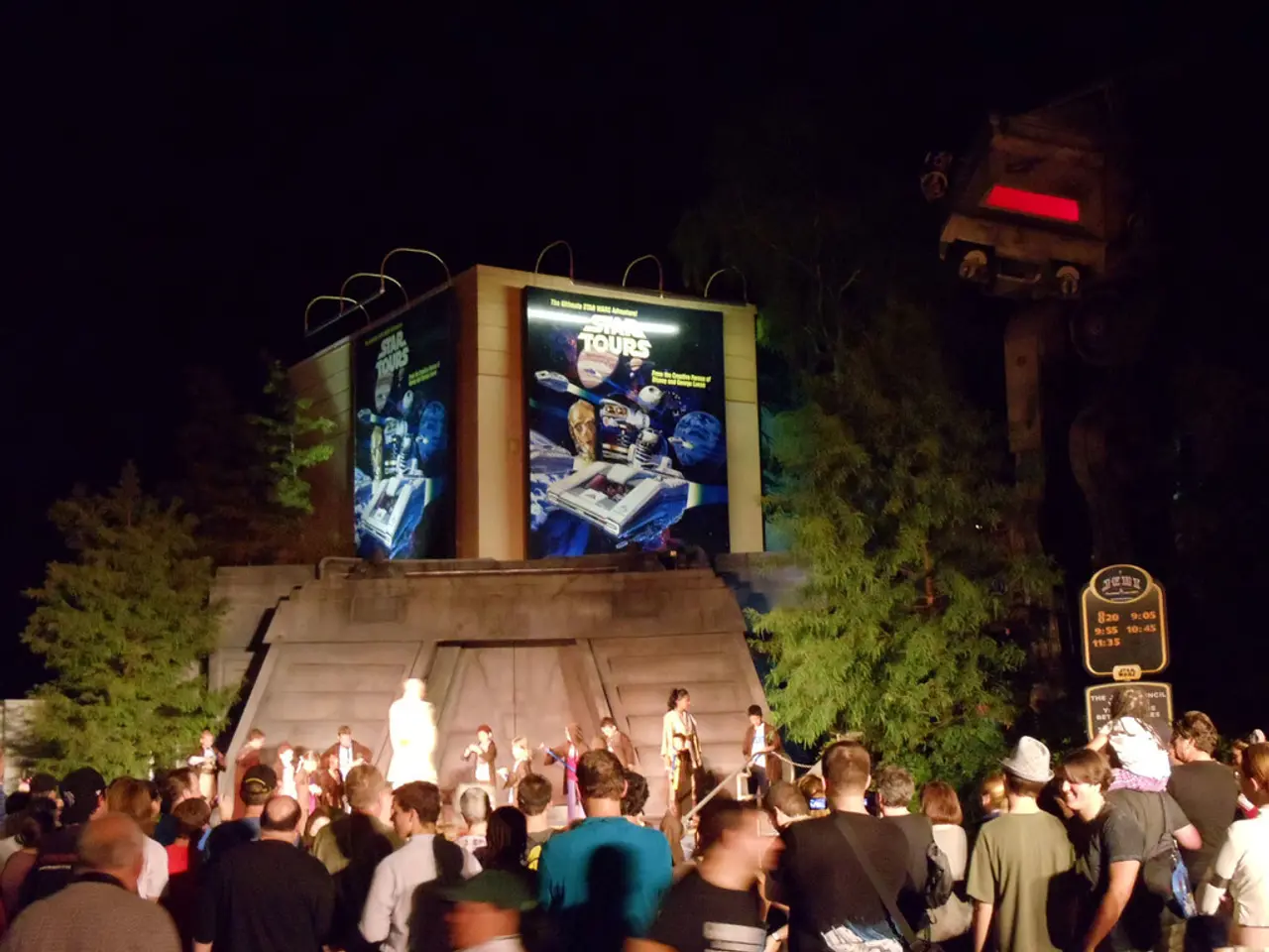 This picture is clicked outside the city. At the bottom of the picture, we see people standing. In...