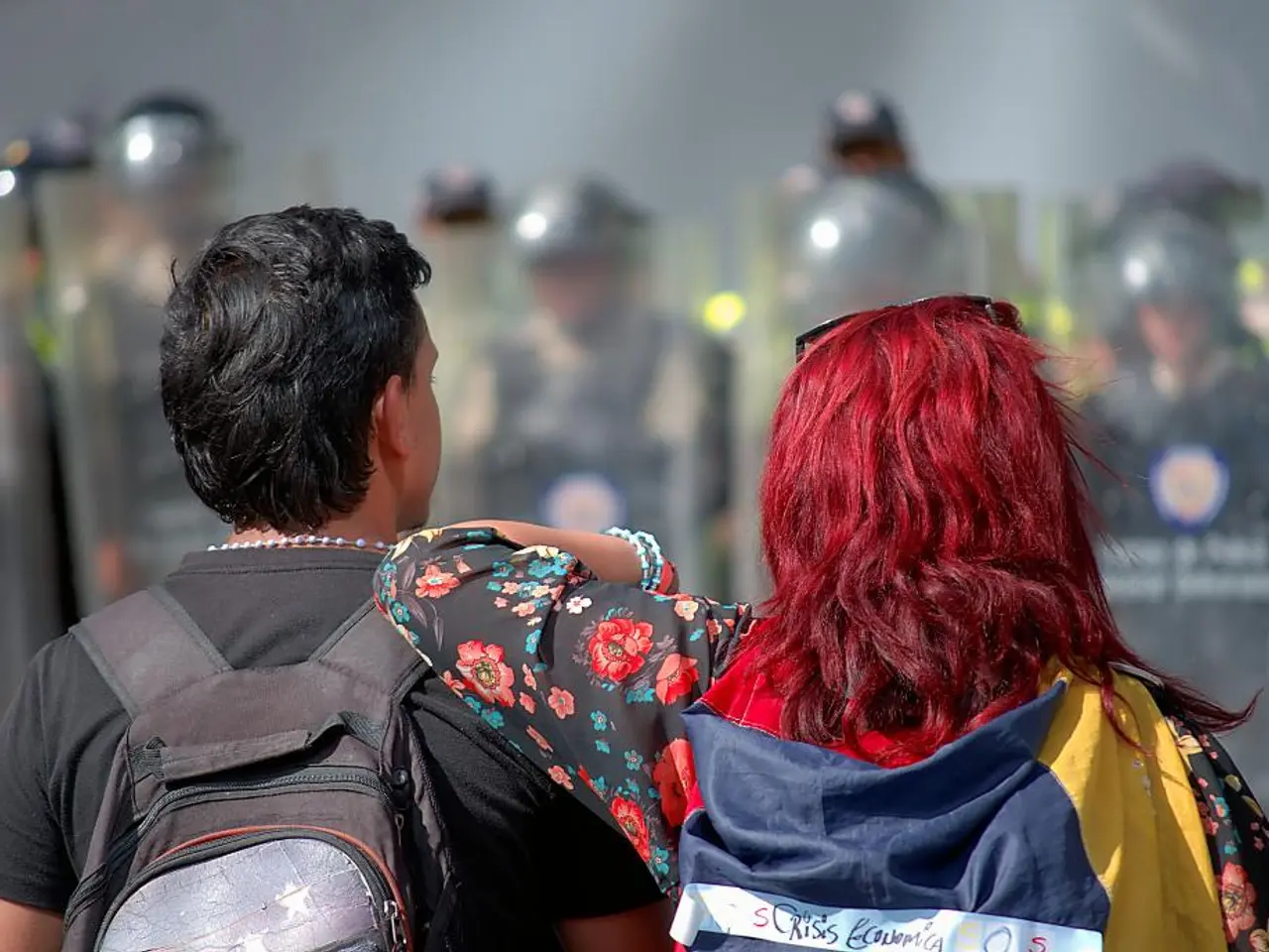 In this picture we can see group of people, on the left side of the image we can see a man, he is...