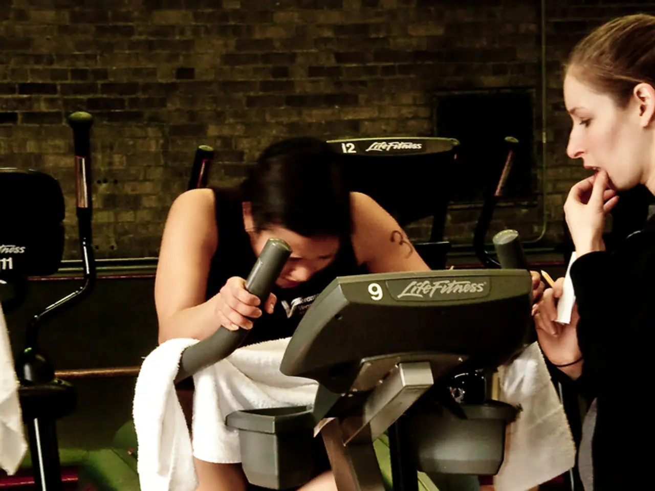 In the center of the image there is a woman on elliptical cycle. On the right side of the image we...