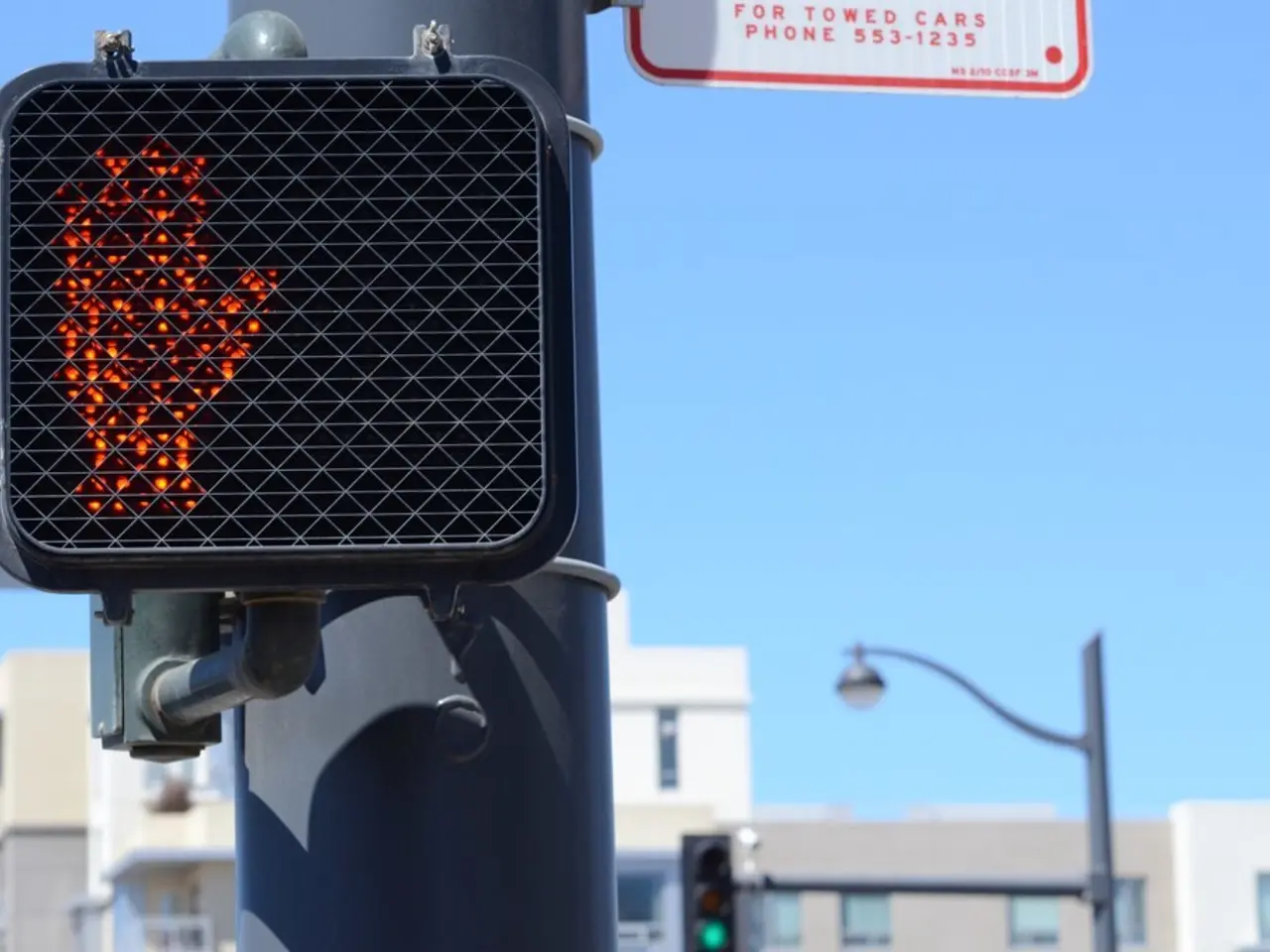 In this image we can see traffic poles, traffic signals, street poles, street lights, buildings and...