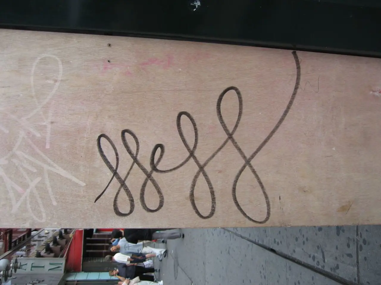 In the image we can see there is a wooden board and there are people standing on the ground. Behind...