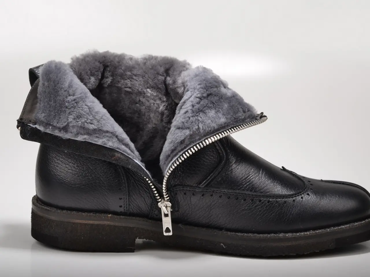 In this image there is a black shoe.