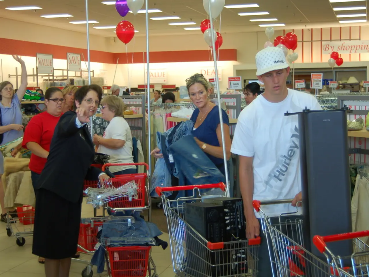 In the picture we can see some people in the shop with some carts and some items in it and in the...