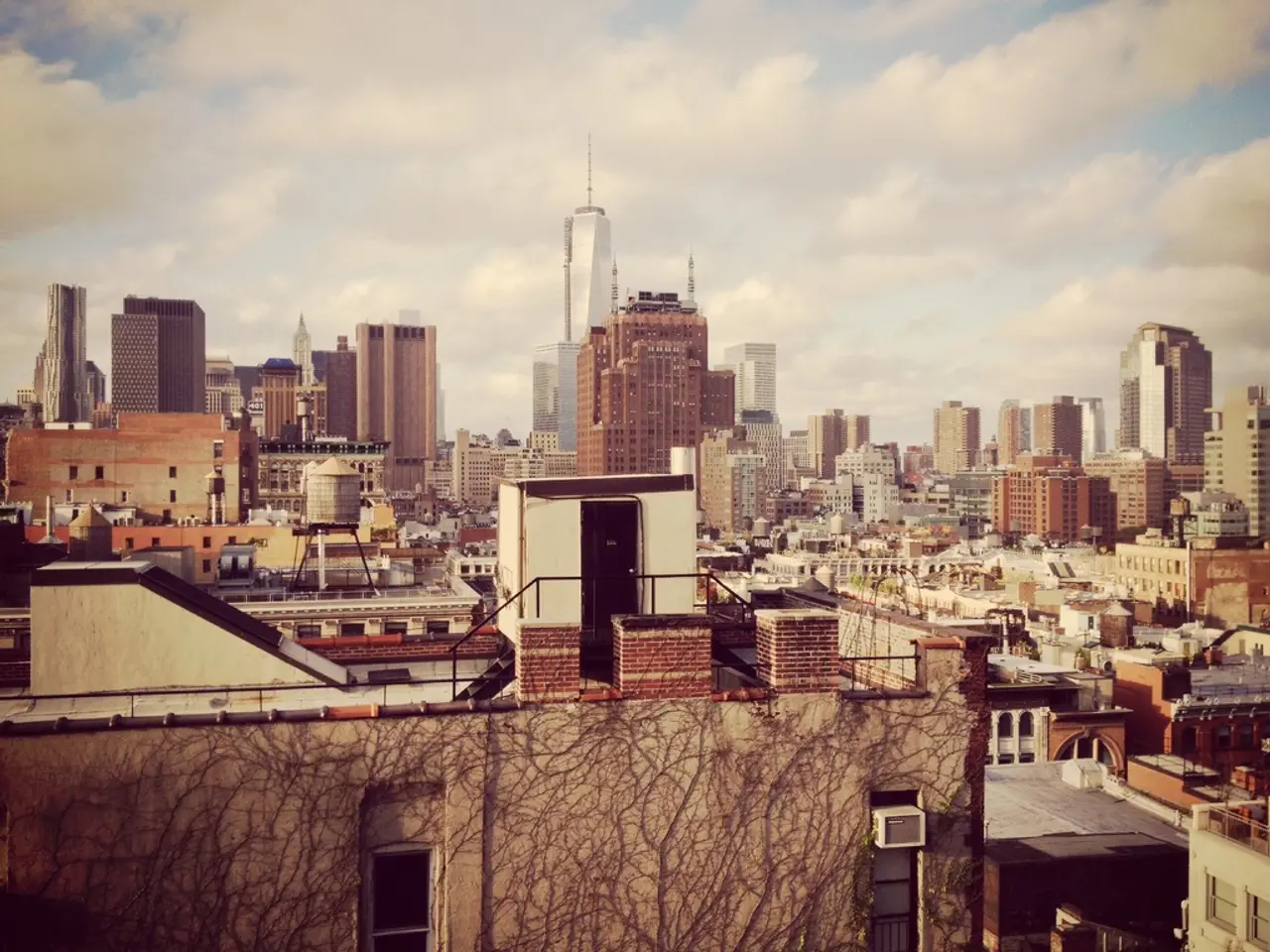 This is a aerial view image of a city with many buildings all over the place and above its sky with...