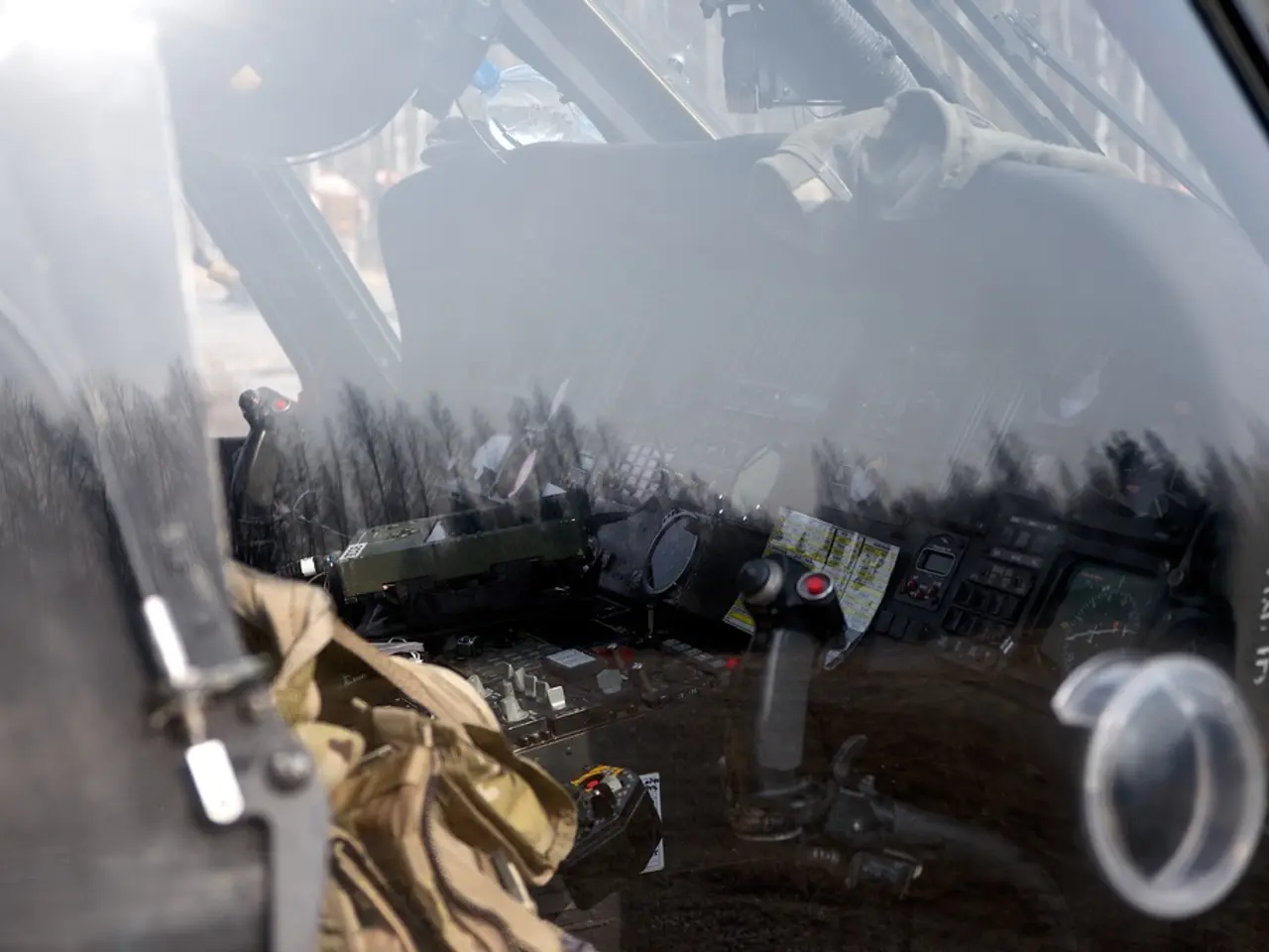 In this image we can see an aircraft which is truncated. Through the glass we can see control...