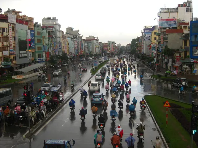 In this image we can see sky, buildings, stores, name boards, sheds, trees, ground, persons on the...