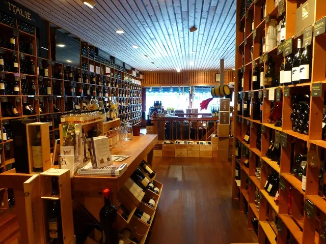 In this image i can see different types of bottles which are on the shelves.