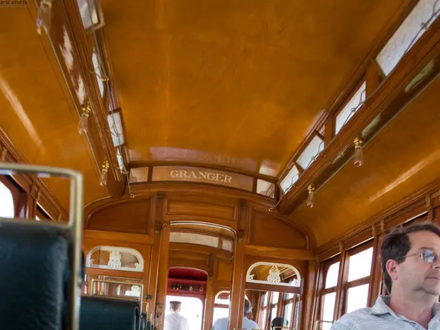 This picture is taken inside the vehicle. Towards the left and right, there are chairs. Towards the...