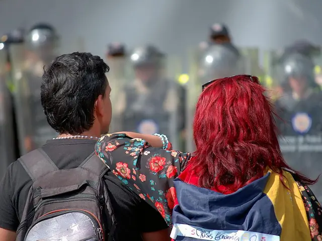 In this picture we can see group of people, on the left side of the image we can see a man, he is...