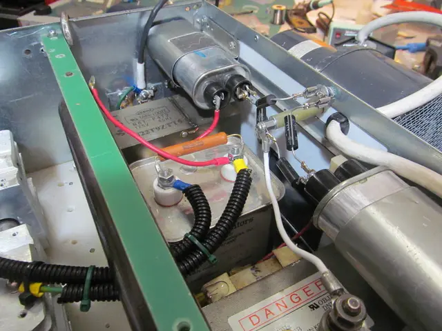 In this image we can see some equipment with cables and nuts.