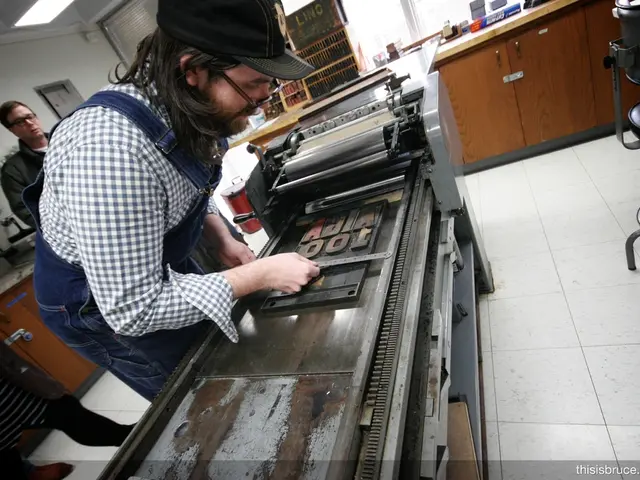 In the picture there is a machine , a man is working with it behind him there are other two people...