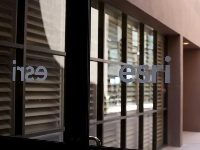 In this image there is a building having a glass wall. Front side of the image there is some text.