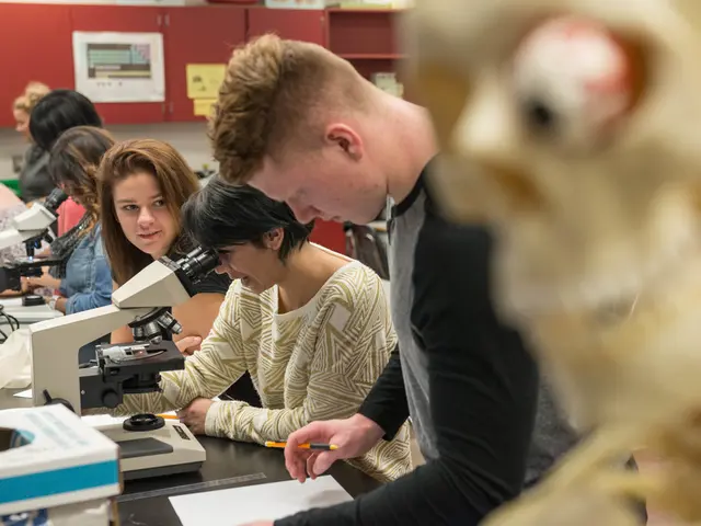 This picture describes about group of people, in front of them we can see papers and some machines...